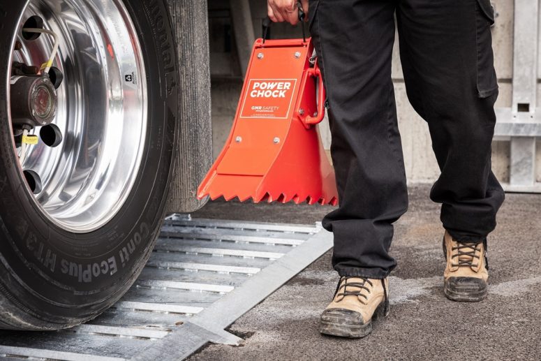 Truck driver moves the POWERCHOCK 3 chock with handle